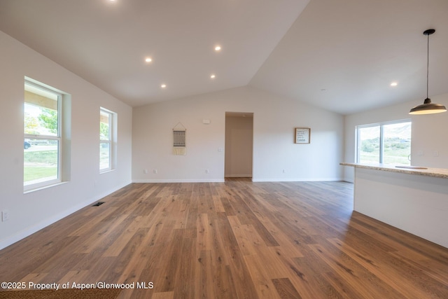 1720 Belgian Loop, Silt, CO 81652 - unfurnished living room with vaulted ceiling, light wood-style flooring, recessed lighting, and baseboards