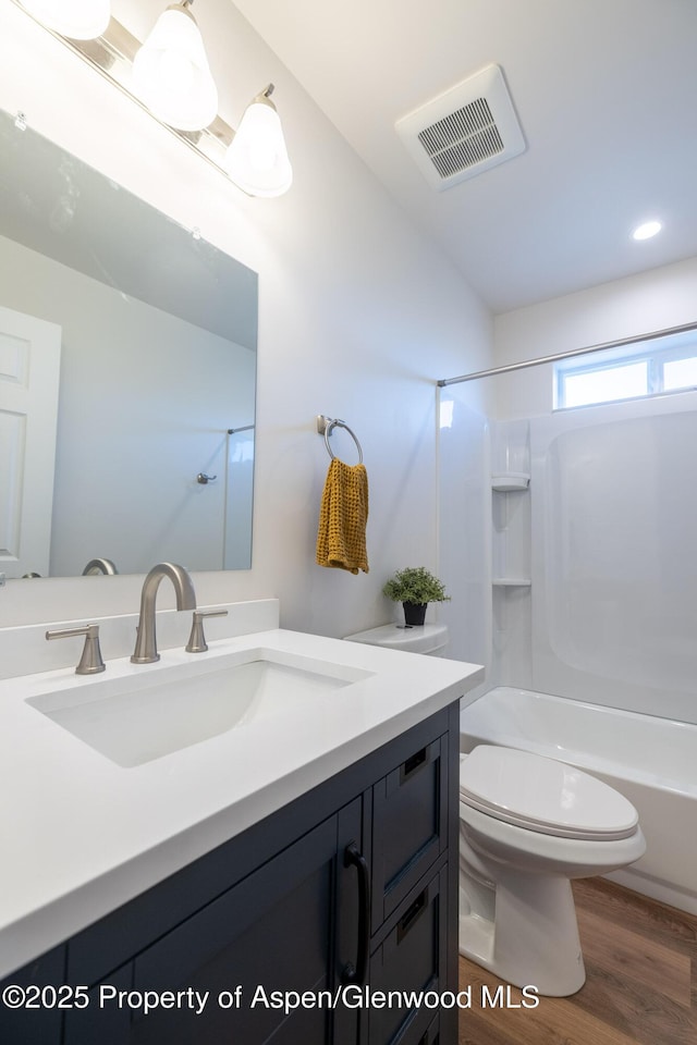 1720 Belgian Loop, Silt, CO 81652 - bathroom with vanity, toilet, tub / shower combination, and wood finished floors