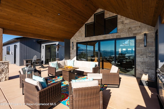 view of patio / terrace with an outdoor living space with a fire pit