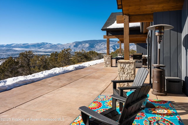 view of patio / terrace with a mountain view and exterior bar