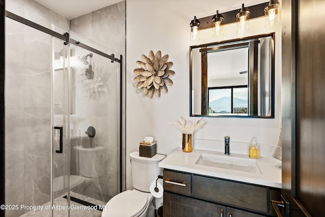 bathroom with walk in shower, vanity, and toilet