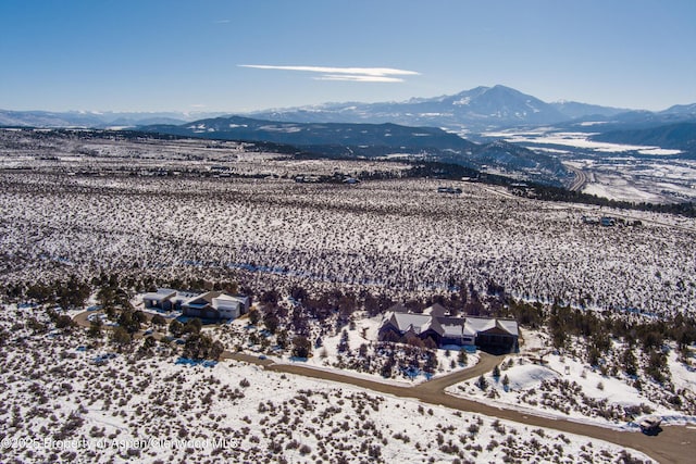 snowy aerial view featuring a mountain view