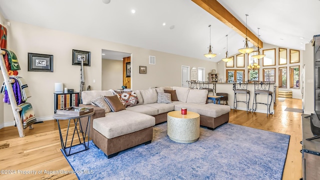 living room with beam ceiling, high vaulted ceiling, and light hardwood / wood-style flooring