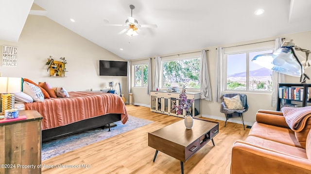 bedroom featuring ceiling fan, light hardwood / wood-style flooring, and vaulted ceiling