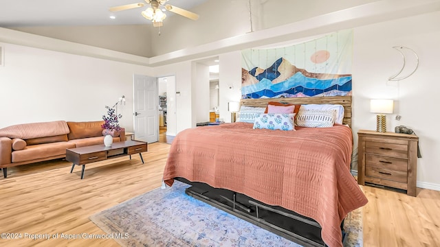 bedroom with hardwood / wood-style flooring, ceiling fan, and high vaulted ceiling