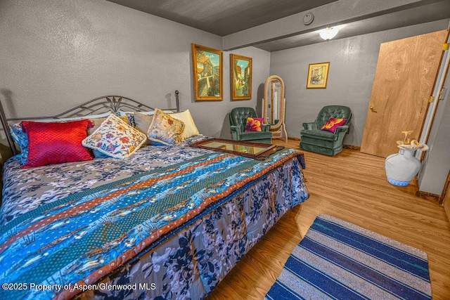 550 County Road 22, Craig, CO 81625 - bedroom with wood finished floors and a textured wall