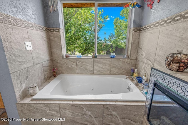 550 County Road 22, Craig, CO 81625 - bathroom featuring a whirlpool tub and tile walls