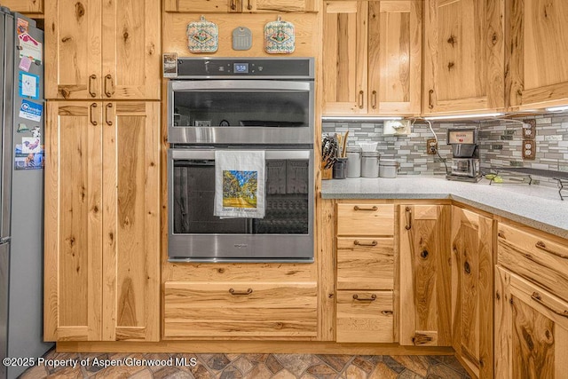 550 County Road 22, Craig, CO 81625 - kitchen with stainless steel appliances, decorative backsplash, and light countertops
