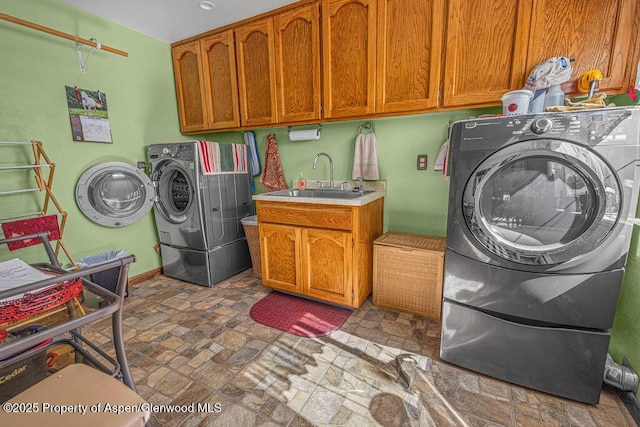 550 County Road 22, Craig, CO 81625 - laundry area with cabinet space, independent washer and dryer, and stone finish flooring