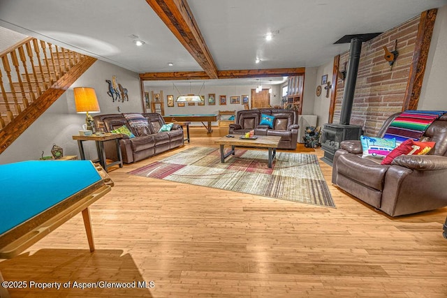 550 County Road 22, Craig, CO 81625 - living room with a wood stove, wood-type flooring, stairway, and beam ceiling