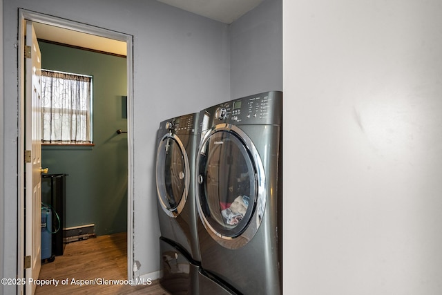 laundry area with washer and dryer, wood finished floors, and laundry area