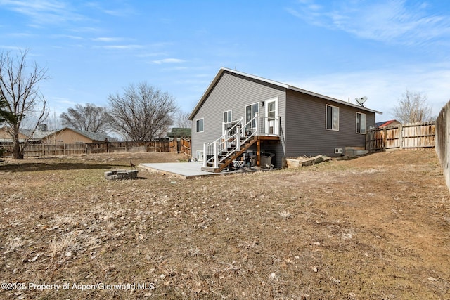back of property with a patio area and a fenced backyard