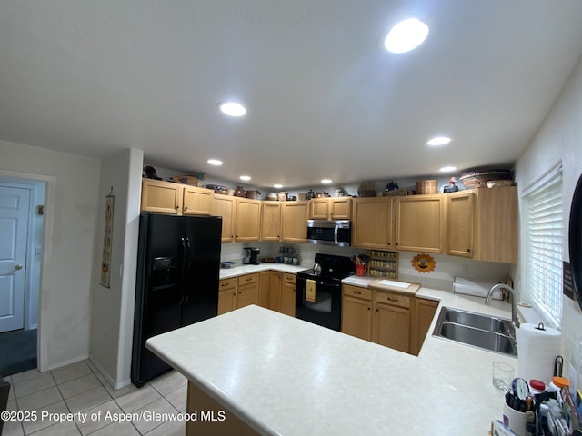 758 Pine Ct, New Castle, CO 81647 - kitchen featuring a peninsula, light tile patterned floors, a sink, black appliances, and light countertops