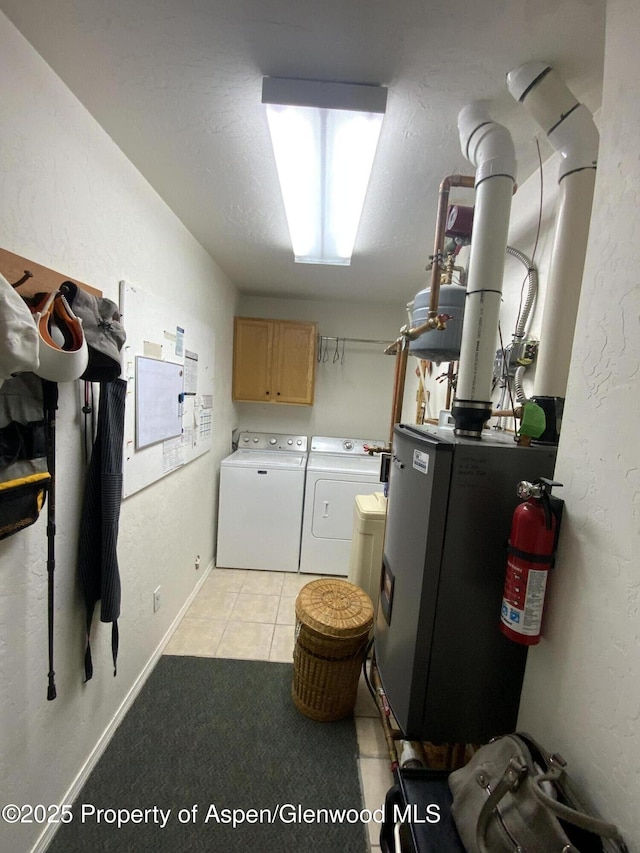 758 Pine Ct, New Castle, CO 81647 - washroom with cabinet space, washer and clothes dryer, and light tile patterned floors