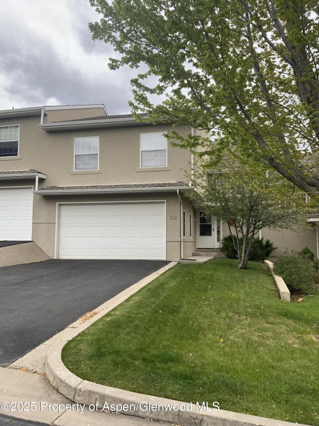 758 Pine Ct, New Castle, CO 81647 - view of front of property with a front yard, stucco siding, aphalt driveway, and an attached garage