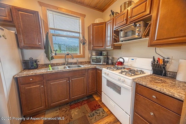 1349 Eagle Loop, Craig, CO 81625 - kitchen featuring white appliances, a sink, wood ceiling, and brown cabinetry