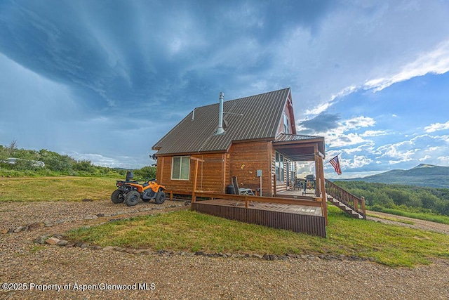 1349 Eagle Loop, Craig, CO 81625 - back of property with a deck with mountain view, metal roof, and stairs