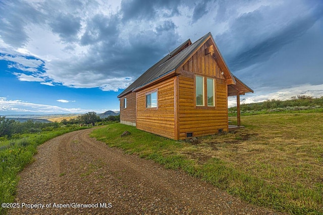 1349 Eagle Loop, Craig, CO 81625 - view of side of home featuring log veneer siding, metal roof, and crawl space