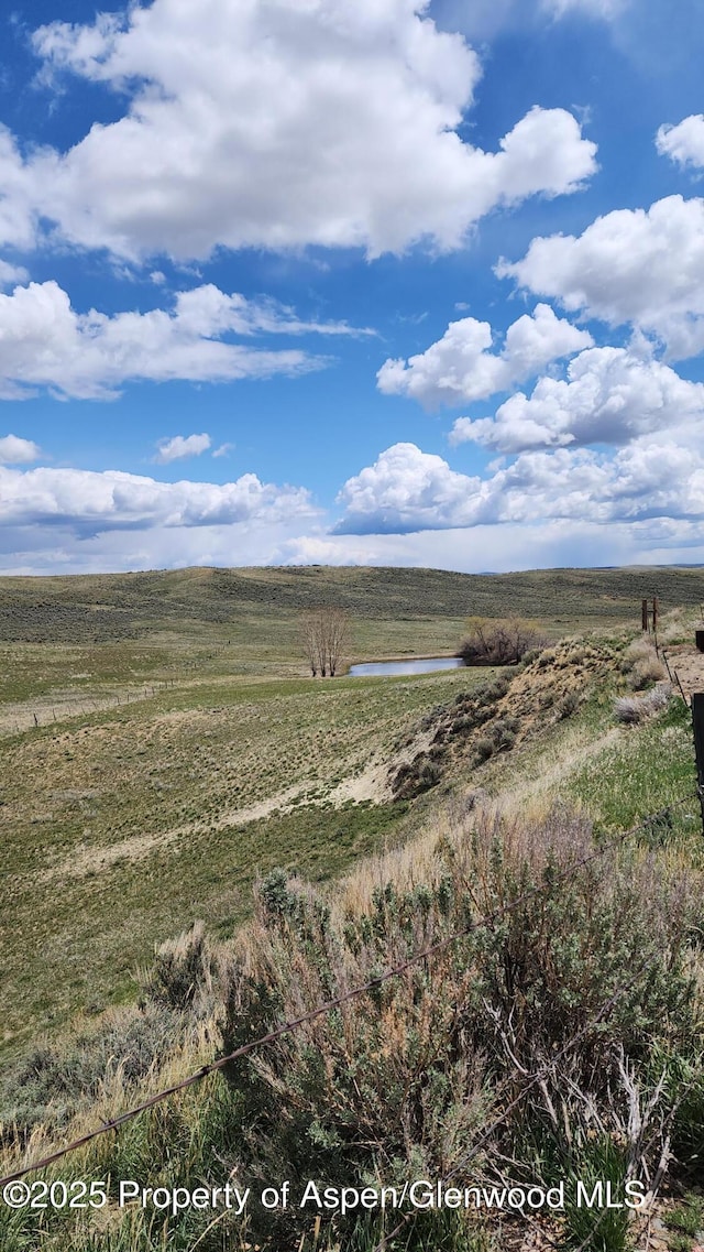 3294 County Road 103, Craig, CO 81625 - view of side of home with fence, stucco siding, an attached garage, and driveway