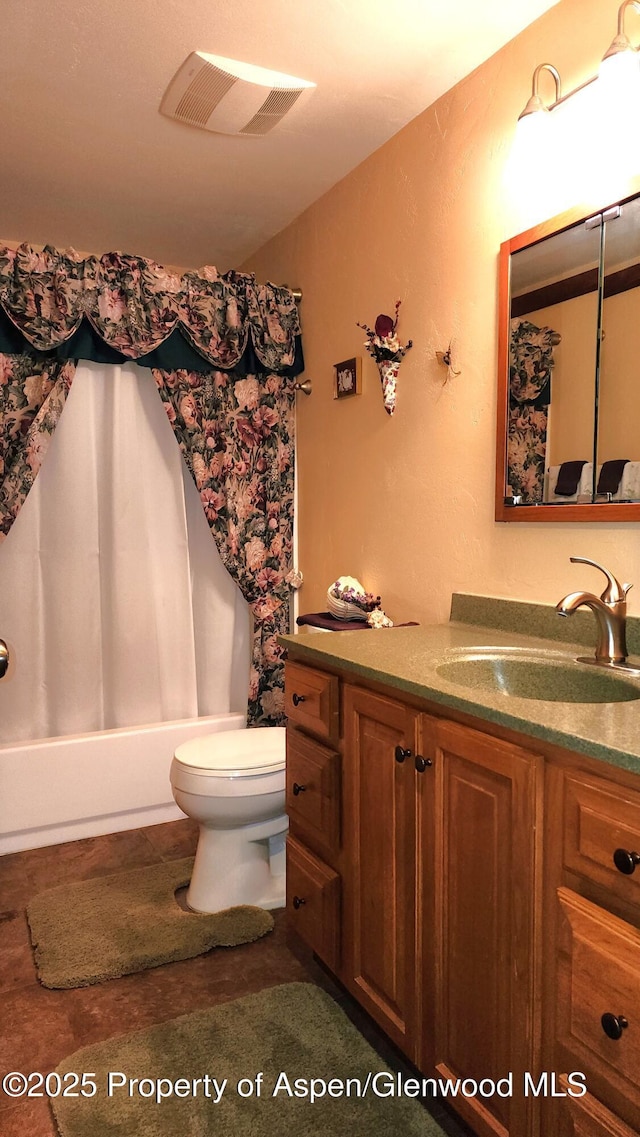 3294 County Road 103, Craig, CO 81625 - full bathroom with toilet, visible vents, shower / bath combination with curtain, and vanity