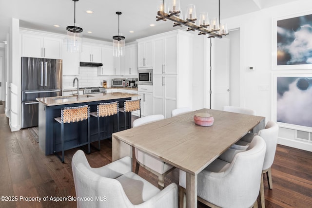 dining room with dark wood-style floors, visible vents, and recessed lighting