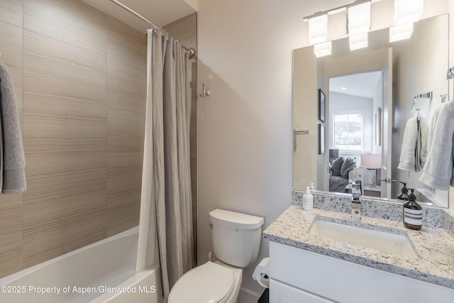 bathroom with vanity, shower / tub combo with curtain, toilet, and ensuite bathroom