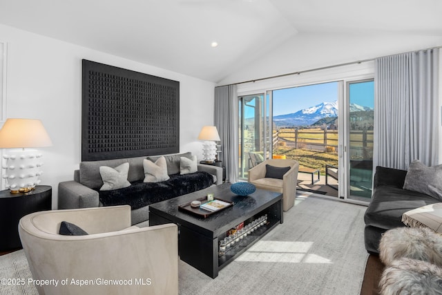 living room with lofted ceiling and a mountain view