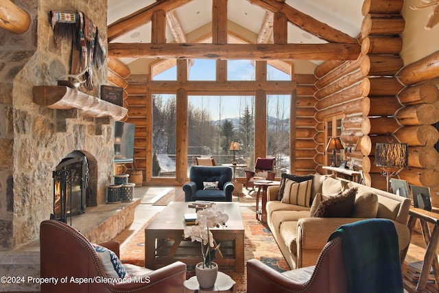 living room with beam ceiling, a stone fireplace, rustic walls, and high vaulted ceiling