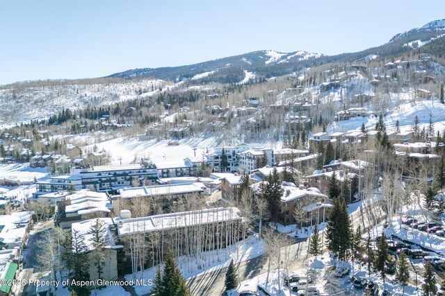 snowy aerial view featuring a mountain view