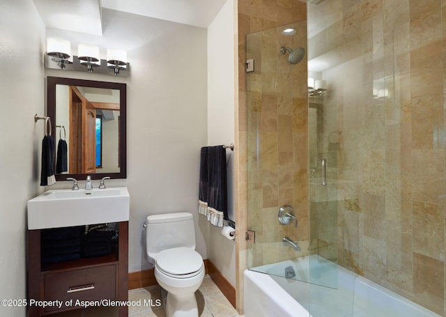 full bathroom with tile patterned flooring, vanity, bath / shower combo with glass door, and toilet