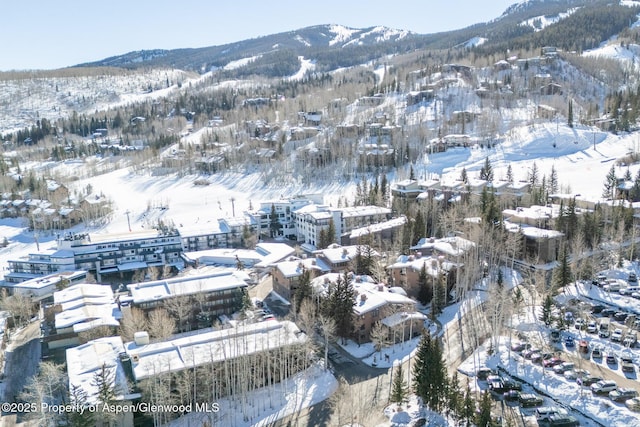 snowy aerial view with a mountain view