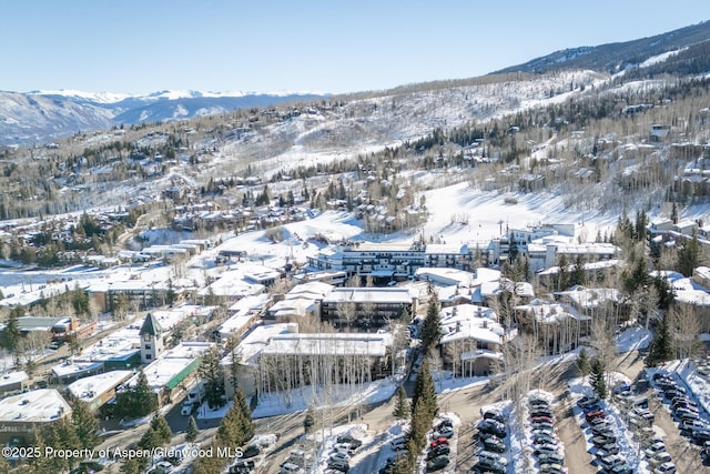 snowy aerial view with a mountain view