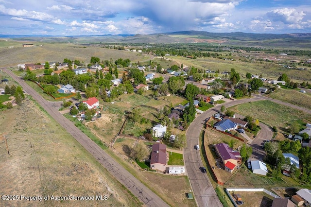 1097 Kowach Dr, Craig, CO 81625 - aerial overview of property's location featuring a mountain backdrop and nearby suburban area