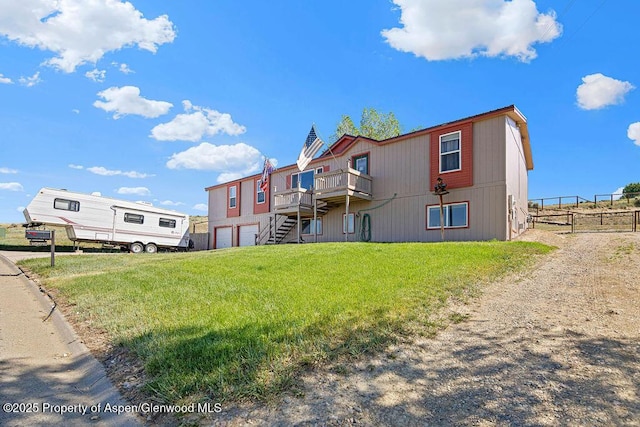 1097 Kowach Dr, Craig, CO 81625 - rear view of property with an attached garage, a deck, and stairs