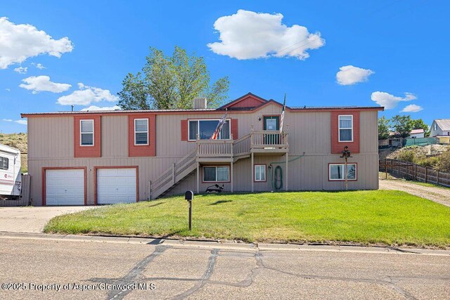 1097 Kowach Dr, Craig, CO 81625 - view of front of home with driveway, stairs, and an attached garage