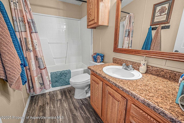 1097 Kowach Dr, Craig, CO 81625 - bathroom with toilet, vanity, wood finished floors, and shower / bath combo with shower curtain