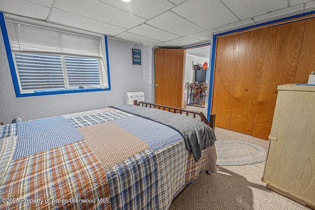 1097 Kowach Dr, Craig, CO 81625 - carpeted bedroom featuring a closet, a textured wall, and a drop ceiling