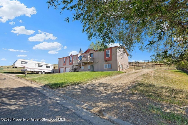 1097 Kowach Dr, Craig, CO 81625 - view of front of home featuring driveway, a deck, and stairs