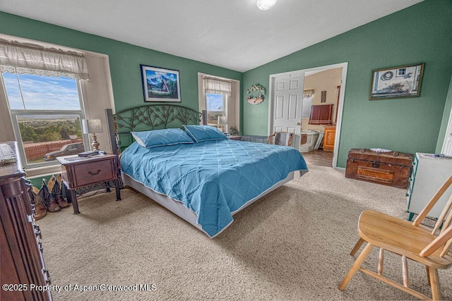 1097 Kowach Dr, Craig, CO 81625 - bedroom featuring multiple windows, vaulted ceiling, carpet flooring, and ensuite bathroom
