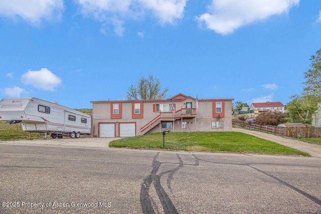 1097 Kowach Dr, Craig, CO 81625 - townhome / multi-family property with concrete driveway, stairs, and an attached garage