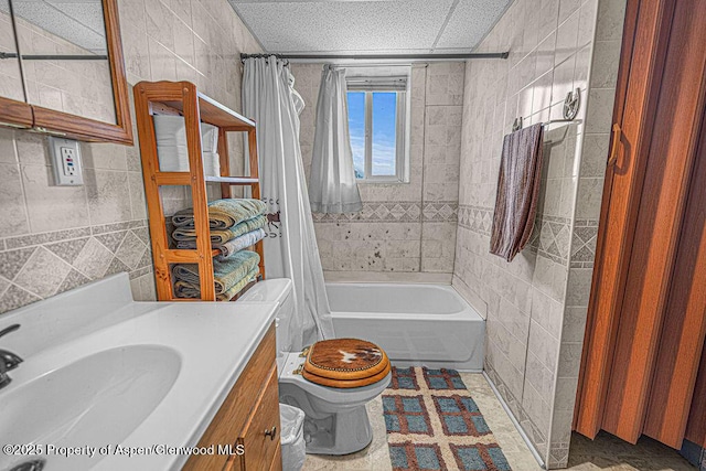 1097 Kowach Dr, Craig, CO 81625 - bathroom featuring toilet, shower / bath combo with shower curtain, vanity, and tile walls