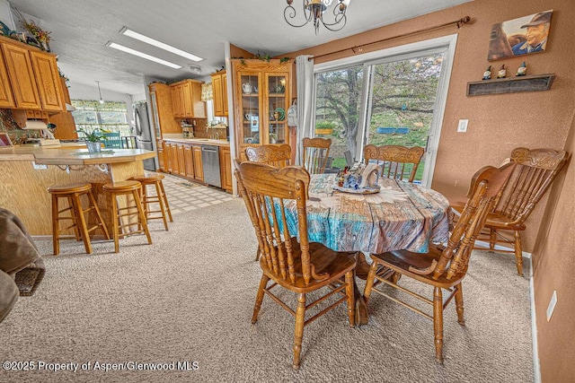 1097 Kowach Dr, Craig, CO 81625 - dining area with a chandelier, light carpet, and a textured wall