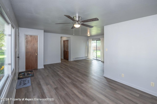 750 Breeze St, Craig, CO 81625 - unfurnished room with baseboard heating, wood finished floors, and a ceiling fan