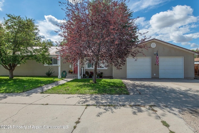 750 Breeze St, Craig, CO 81625 - view of property hidden behind natural elements featuring driveway, an attached garage, and a front lawn