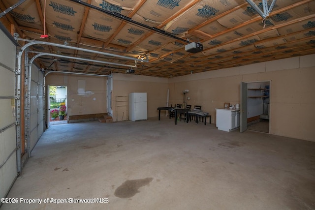 750 Breeze St, Craig, CO 81625 - garage with freestanding refrigerator and a garage door opener