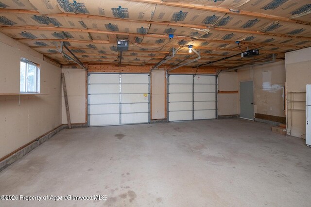 750 Breeze St, Craig, CO 81625 - garage with a garage door opener and freestanding refrigerator