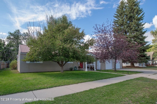 750 Breeze St, Craig, CO 81625 - view of property hidden behind natural elements with concrete driveway and a metal roof
