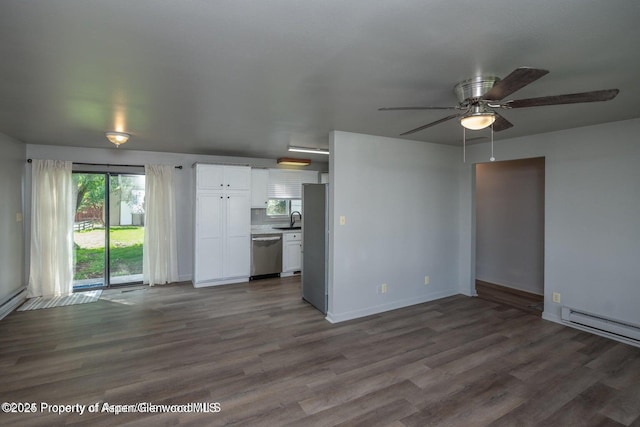 750 Breeze St, Craig, CO 81625 - unfurnished living room featuring a ceiling fan, wood finished floors, and a baseboard heating unit