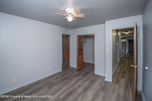 750 Breeze St, Craig, CO 81625 - unfurnished bedroom with wood finished floors, a closet, and a ceiling fan
