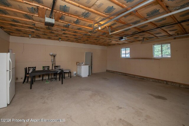 750 Breeze St, Craig, CO 81625 - garage with freestanding refrigerator and a garage door opener